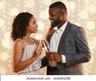 Beautiful Black Couple Drinking Champagne Outdoors, Having Date