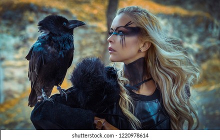 Beautiful black crow, Viking blonde woman with shield and sword, braids in her hair.