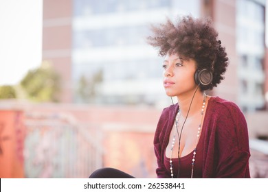 Beautiful Black Curly Hair African Woman Listening Music With Headphones In Town