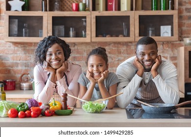 Beautiful Black Family Making Healthy Dinner Together, Leaning Their Chins On Arms And Smiling At Camera, Free Space