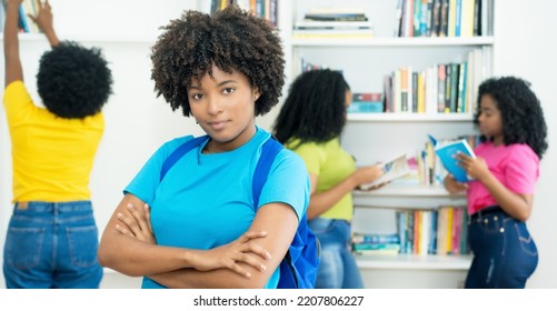 Beautiful Black Female Student With Group Of African American College Students Indoors At Library