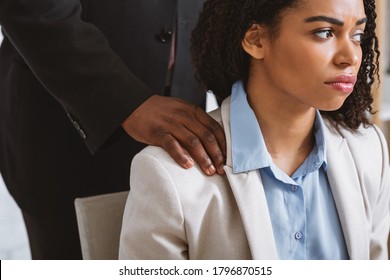 Beautiful black girl being victim of sexual harassment at worlplace, copy space