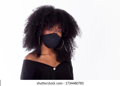 Beautiful Black Girl With Great Hair, Wearing Black Protective Mask, Due To The Coronavirus. Photographed On A White Background