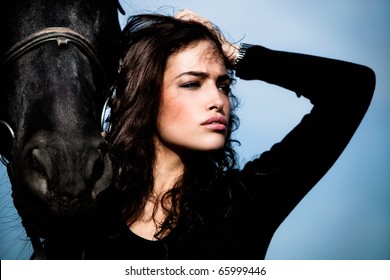 Beautiful Black Hair Woman And Black Horse Outdoor Day Shot