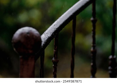 Beautiful black handrail wrought iron exterior spiral staircase on the side of a house on a rainy autumn day, macro shot of steel spiral staircase with small water drops, close up - Powered by Shutterstock