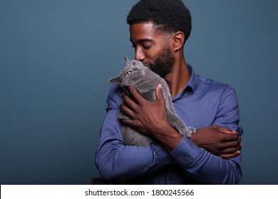 Beautiful Black Man With A Cute Cat In Front Of A Background