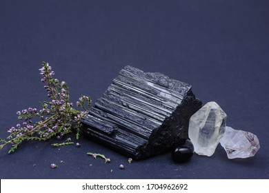 beautiful black tourmaline , amethyst, smoky quartz on a black background with heather branch