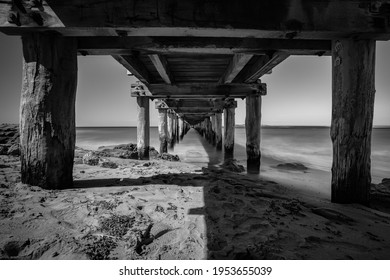 A beautiful black and white photo under the pier