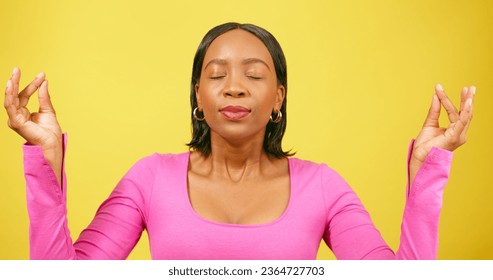 Beautiful Black woman breathes and meditates, feeling relax happy, yellow studio - Shutterstock ID 2364727703