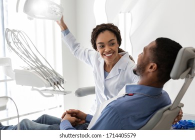 Beautiful Black Woman Dentist Greeting Male Patient On Her Workplace, Copy Space