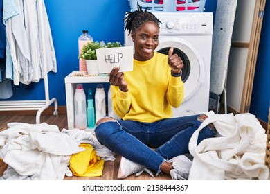 Beautiful Black Woman Doing Laundry Asking For Help Smiling Happy And Positive, Thumb Up Doing Excellent And Approval Sign 