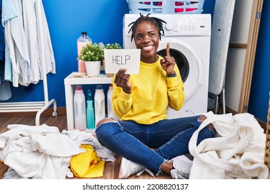 Beautiful Black Woman Doing Laundry Asking For Help Surprised With An Idea Or Question Pointing Finger With Happy Face, Number One 