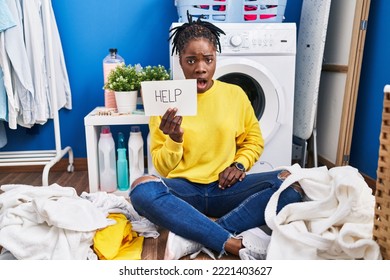 Beautiful Black Woman Doing Laundry Asking For Help Scared And Amazed With Open Mouth For Surprise, Disbelief Face 