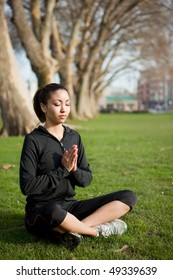 A Beautiful Black Woman Doing Yoga Meditation Outdoor In A Park