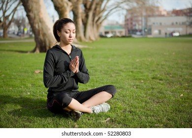 A Beautiful Black Woman Doing Yoga Meditation Outdoor In A Park