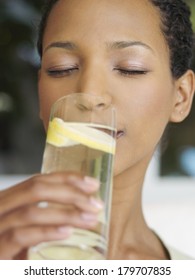 Beautiful Black Woman Drinking Water With Lemon