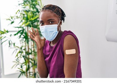 Beautiful Black Woman Getting Vaccine Showing Arm With Band Aid Celebrating Victory With Happy Smile And Winner Expression With Raised Hands 