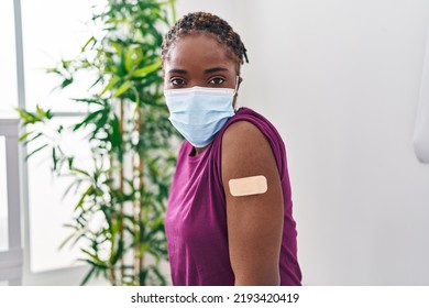 Beautiful Black Woman Getting Vaccine Showing Arm With Band Aid Thinking Attitude And Sober Expression Looking Self Confident 