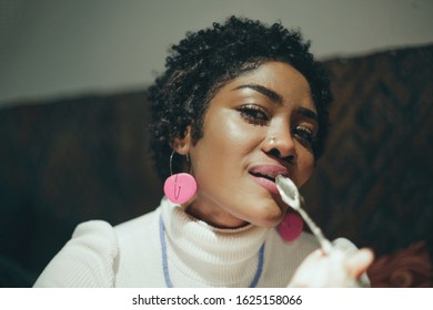 Beautiful Black Woman Licking A Spoon And Smiling.