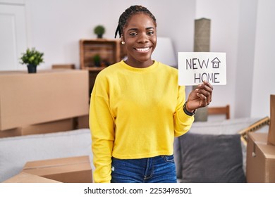 Beautiful black woman moving to a new home looking positive and happy standing and smiling with a confident smile showing teeth  - Shutterstock ID 2253498501