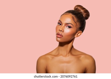Beautiful Black Woman posing in studio on peach background. Fashion Portrait Black Woman in white stylish linen dress. Makeup, curly Hair.     