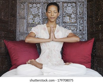 Beautiful Black Woman At Spa Meditating And Practicing Yoga