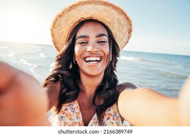 Beautiful Black Woman Taking Selfie At The Beach - African Female Having Fun On A Sunny Day At Summer Vacation 