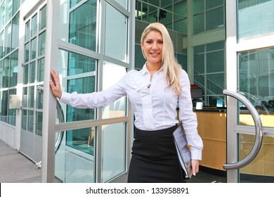 A Beautiful Blond Business Woman Open The Office Door