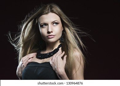 Beautiful Blond Girl With Blowing Hair In Studio