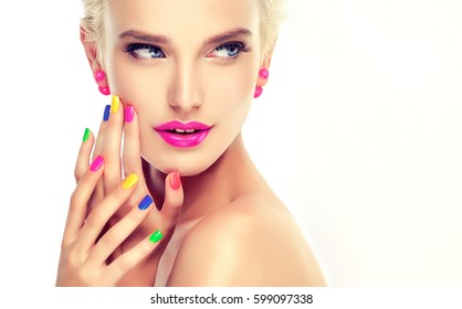 Beautiful Blond Girl With Colorful Manicure Nails .Crimson Lips And Earrings. Cosmetics,makeup And Beauty