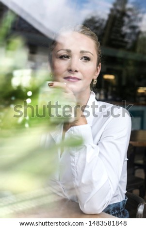 Similar – Young woman looking at cellphone