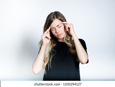 beautiful blond girl has a headache, migraine, isolated studio photo on background