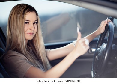 Beautiful blond girl in her car - Shutterstock ID 98382878