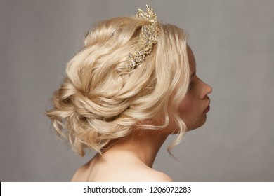 Beautiful blond girl in the image of a bride with a tiara in her hair.