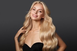 Beautiful Blond Girl With A Perfectly Curls Hair, And Classic Make-up. Beauty Face And Hair.
