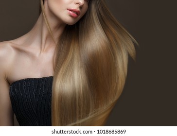 Beautiful blond girl with a perfectly smooth hair, classic make-up. Beauty face. Picture taken in the studio on a white background.