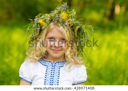 Beautiful blond girl with a wreath of flowers looking at you