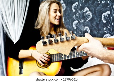 Beautiful Blond Glam Rocked Woman With Guitar Sitting In Front O