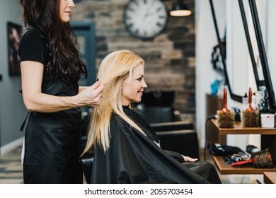 Beautiful blond middle-aged woman in modern hair salon. - Powered by Shutterstock