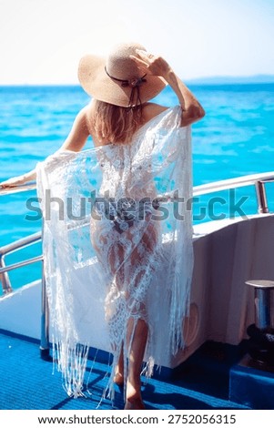 Beautiful blond model posing on a boat with a great seaview in Greece 