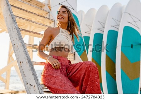 Similar – Surfer woman with bikini and wetsuit holding surfboard