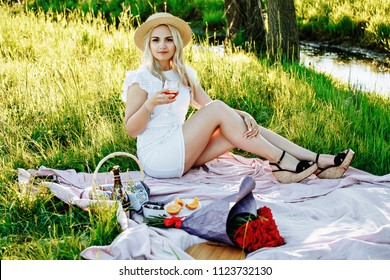 Beautiful blond woman enjoying a pick nick outdoors. Pick nick for one.