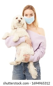 Beautiful Blond Woman In Face Mask With A Cute Dog
