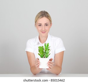 Beautiful Blond Woman Holding Plant Pot