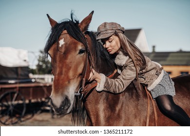 Beautiful blond woman with a horse on the ranch