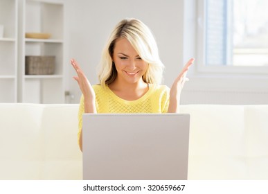 Beautiful Blond Woman With A Laptop Computer At Home