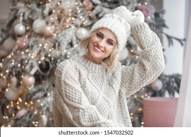 Beautiful Blond Woman On Christmas Background. Beauty Near Cristmas Tree. Close Up Portrait Of Attractive Female.