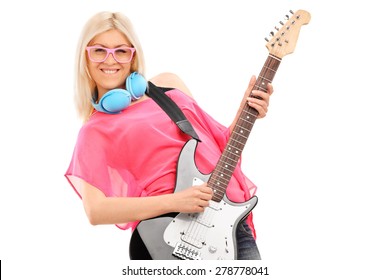 Beautiful Blond Woman Playing An Electric Guitar And Wearing Blue Headphones Around Her Neck Isolated On White Background