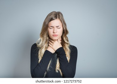 Beautiful Blond Woman With Sore Throat, Isolated Over Black Background