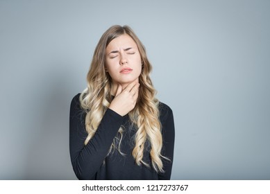 Beautiful Blond Woman With Sore Throat, Isolated Over Black Background